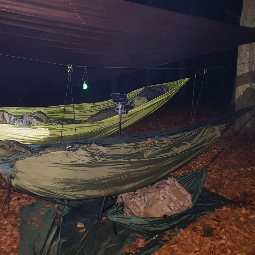 DD Gear Sling in use with hammocks at night, showcasing camping gear organized and elevated off the ground. DD Gear Sling in use with hammocks at night, showcasing camping gear organized and elevated off the ground.