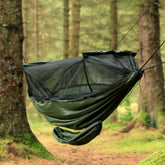 DD Gear Sling attached to a hammock in a forest, providing a storage solution for camping gear.