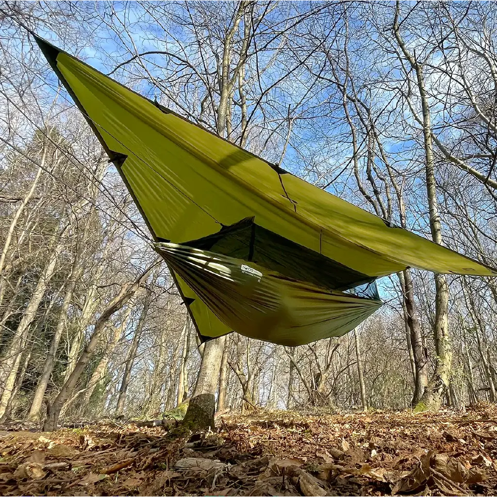 DD Recycled Frontline Hammock suspended in a forest, made from 258 recycled plastic bottles, showcasing eco-friendly design. DD Recycled Frontline Hammock suspended in a forest, made from 258 recycled plastic bottles, showcasing eco-friendly design.