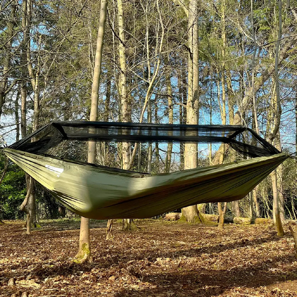 DD Recycled Frontline Hammock hanging in forest, featuring bugproof design and made from recycled plastic bottles. DD Recycled Frontline Hammock hanging in forest, featuring bugproof design and made from recycled plastic bottles.