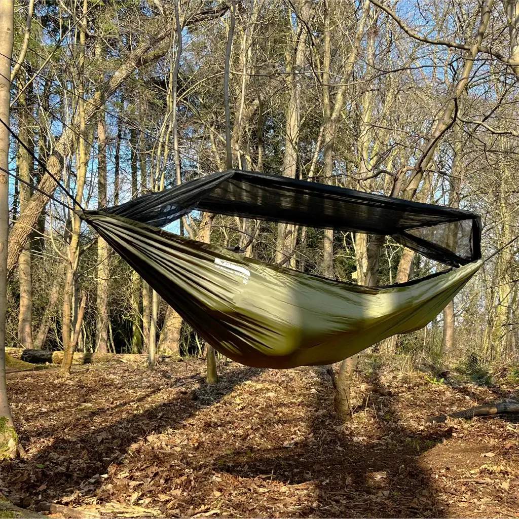 DD Recycled Frontline Hammock hanging in the woods, made from recycled plastic bottles, featuring bugproof design. DD Recycled Frontline Hammock hanging in the woods, made from recycled plastic bottles, featuring bugproof design.