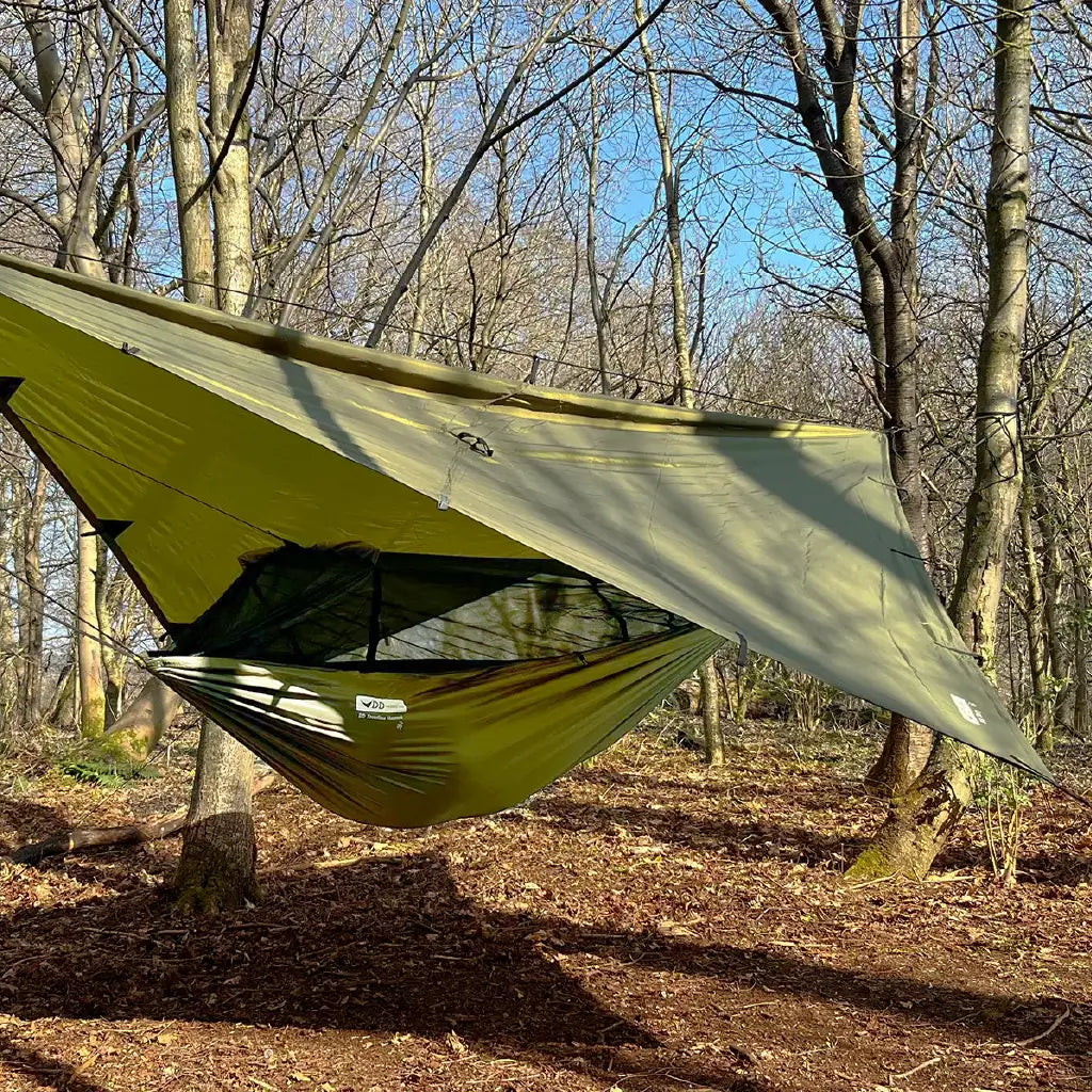 DD Recycled Frontline Hammock in a forest setting, featuring bugproof design and sustainable materials. DD Recycled Frontline Hammock in a forest setting, featuring bugproof design and sustainable materials.