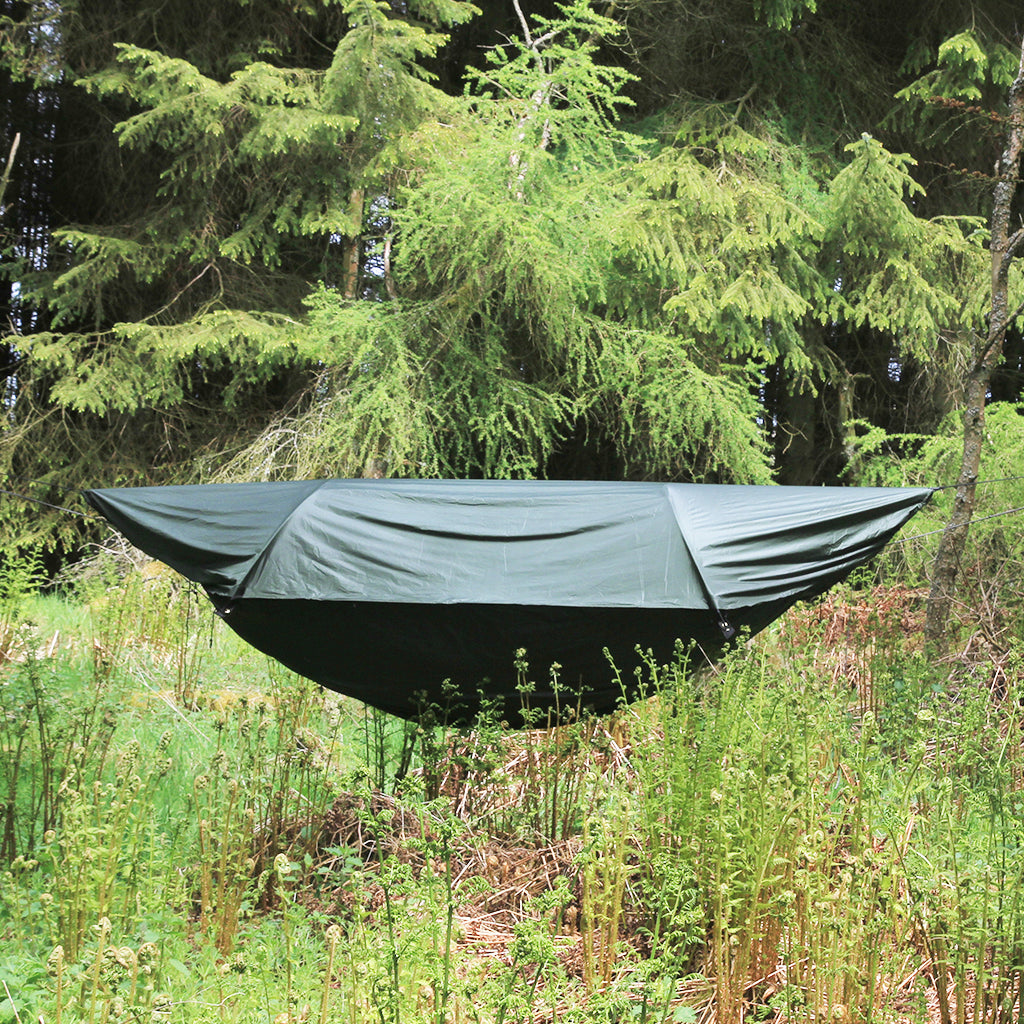 DD Superlight Jungle Hammock set up in a forest, showcasing its modular design and waterproof layer. DD Superlight Jungle Hammock set up in a forest, showcasing its modular design and waterproof layer.
