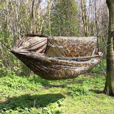 DD Nest Hammock in DD Multicam pattern, designed for covert camping in woodland environments.