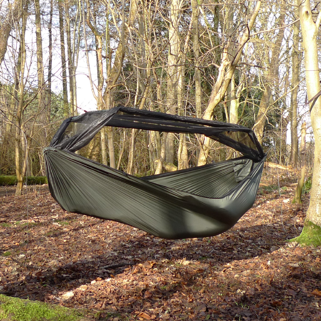 DD Hammocks Superlight Frontline Hammock hanging in a forest, showcasing lightweight ripstop nylon design. DD Hammocks Superlight Frontline Hammock hanging in a forest, showcasing lightweight ripstop nylon design.