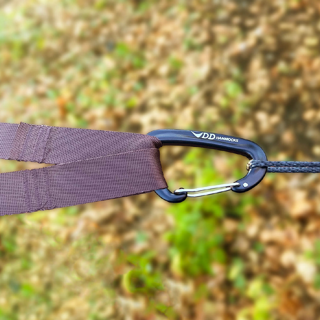 Close-up of DD Hammocks Superlight carabiner and tree hugger strap, ideal for outdoor adventures. Close-up of DD Hammocks Superlight carabiner and tree hugger strap, ideal for outdoor adventures.