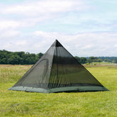 DD Superlight Pyramid Mesh Tent set up in a grassy field, ideal for lightweight backpacking and versatile camping.