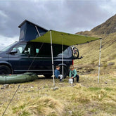 DD Hammocks Campervan Tarp providing shelter for kids near a camper in a scenic outdoor setting.