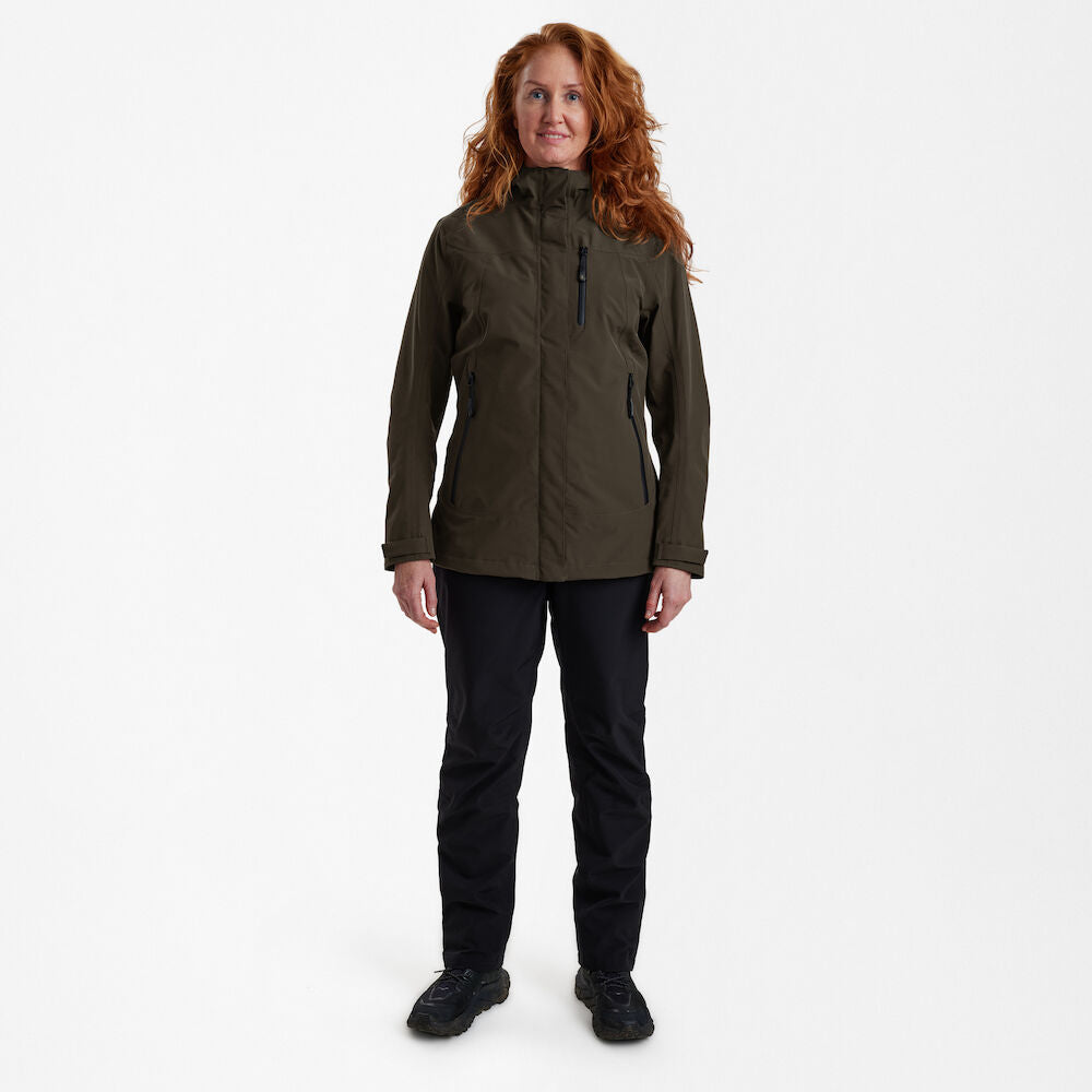 Woman wearing Lady Sarek Shell Jacket with hood, showcasing waterproof and breathable outdoor apparel. Woman wearing Lady Sarek Shell Jacket with hood, showcasing waterproof and breathable outdoor apparel.