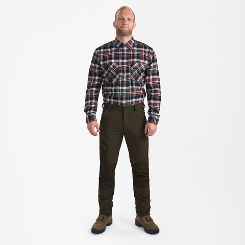 Man wearing Northward Trousers by DEERHUNTER with a plaid shirt and boots, demonstrating comfort and functionality. Man wearing Northward Trousers by DEERHUNTER with a plaid shirt and boots, demonstrating comfort and functionality.