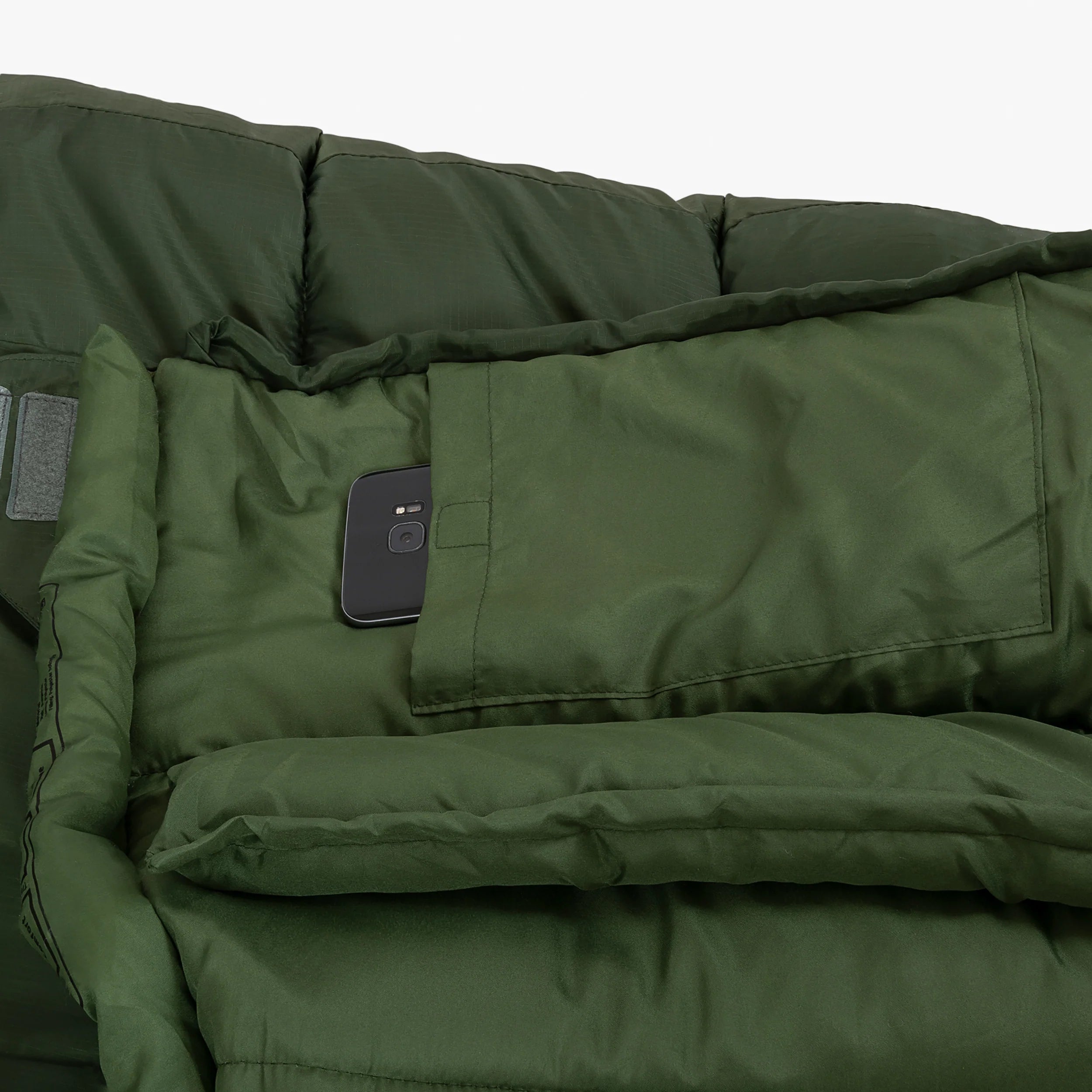 Interior pocket of the Phoenix Ember 250 mummy sleeping bag with a smartphone visible, showcasing convenience and practicality. Interior pocket of the Phoenix Ember 250 mummy sleeping bag with a smartphone visible, showcasing convenience and practicality.