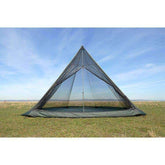 DD Hammocks SuperLight Tipi with mesh inner on grassy landscape, ideal for lightweight camping and backpacking.