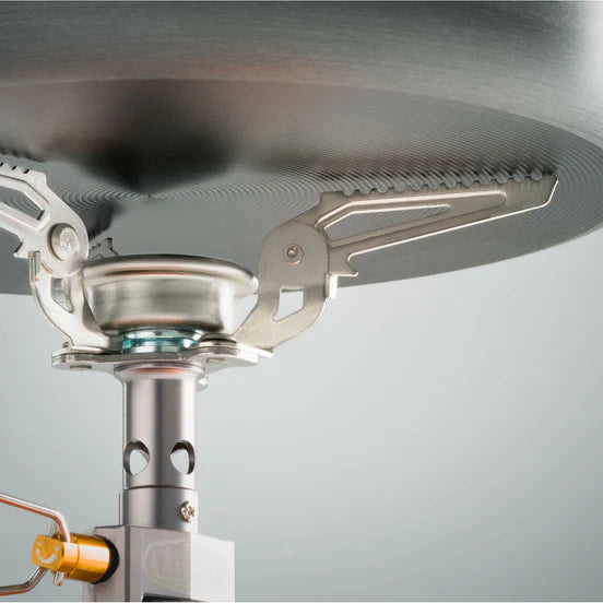 Close-up of a camping stove with a gray background
