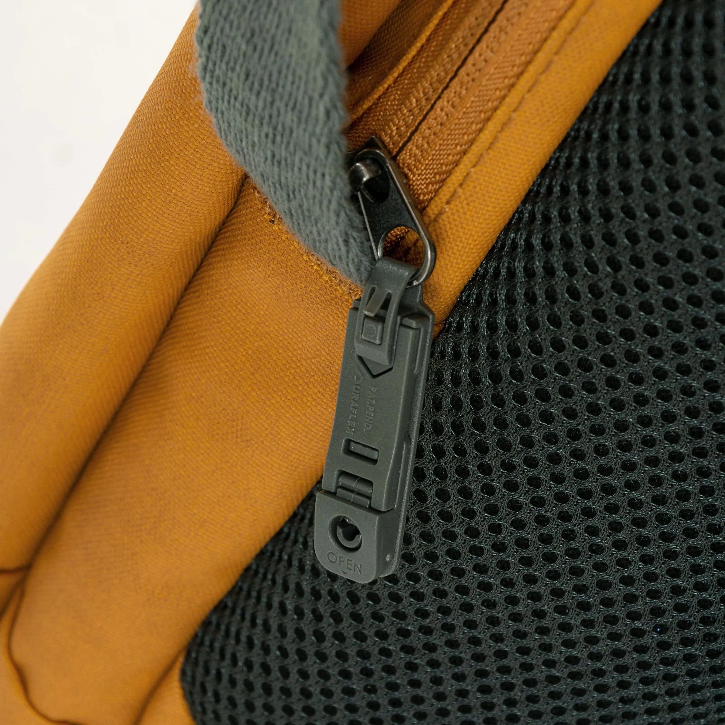 Close-up of the zipper and mesh fabric on the Flug Urban Laptop Backpack, showcasing its stylish design.
