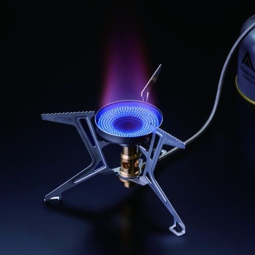 Portable gas stove with blue flame on a black background
