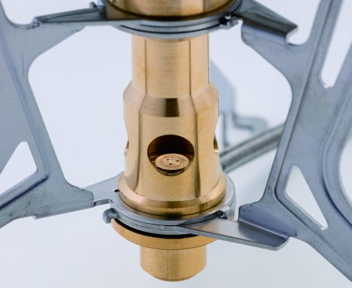 Close-up of a brass stove component on a white background