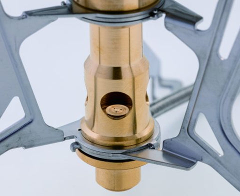 Close-up of a brass stove component on a white background