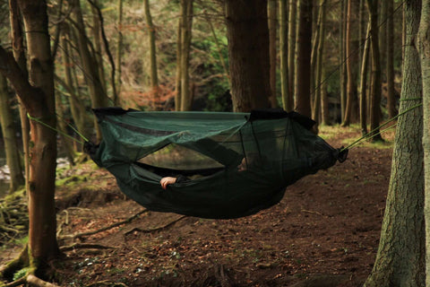 DD Hammock Mosquito Net offering insect protection in a forest setting, featuring zippered entry and secure closure.