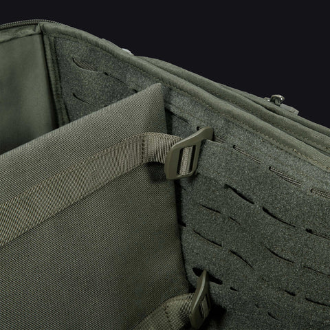 Close-up of a tactical pouch with a buckle and MOLLE webbing on a black background