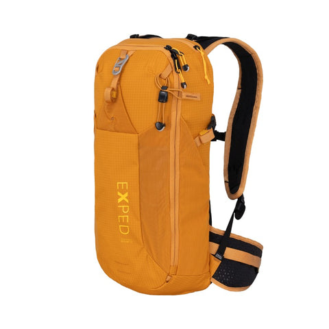 Skyline 12 ultra-compact backpack in orange, ideal for hikes, multisports, and everyday use with breathable straps.
