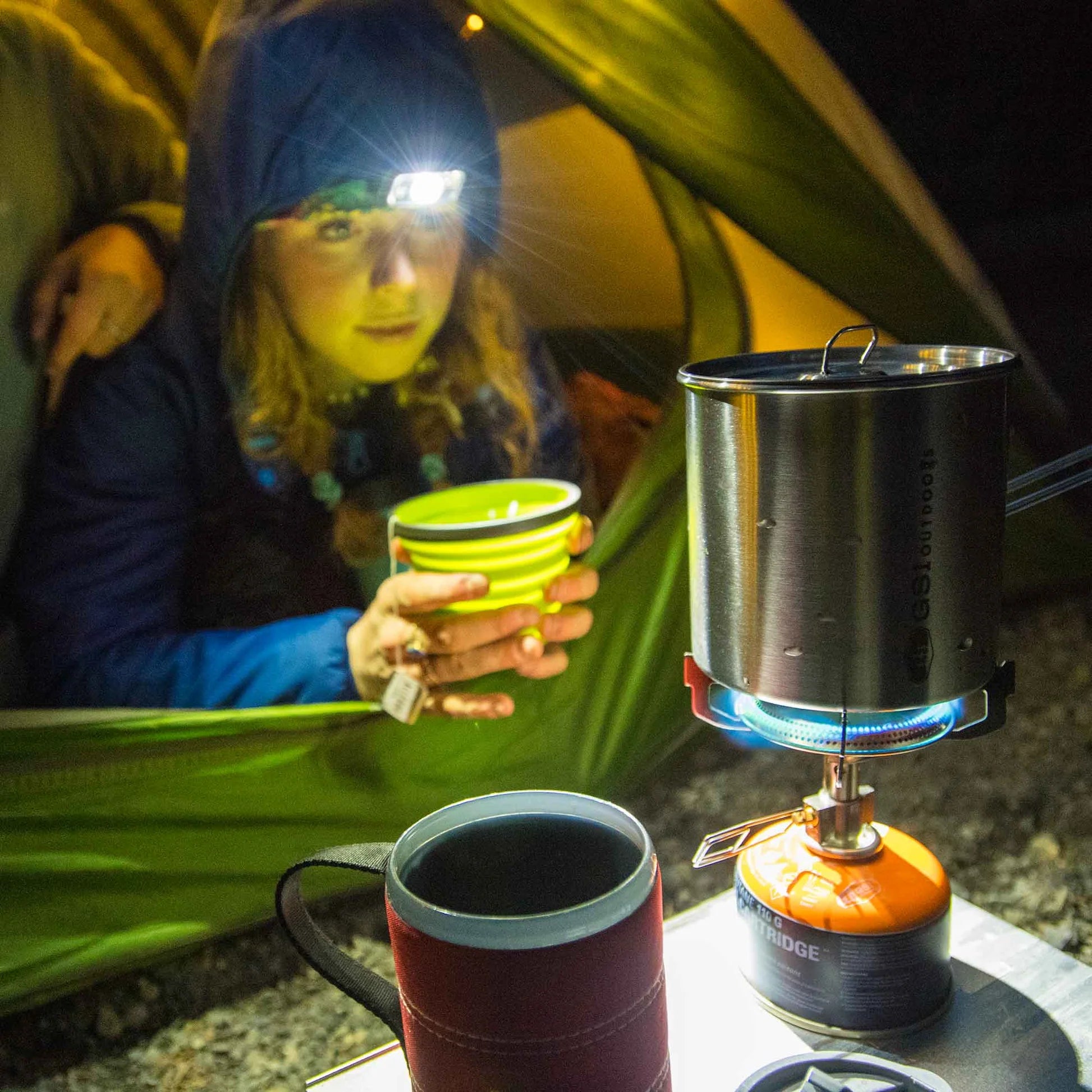 GSI Glacier stove in outdoor camping environment with cookware
