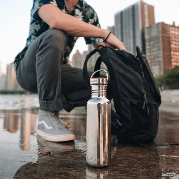 klean_kanteen_reflect_stainless_steel_water_bottle_on_city_street_with_bamboo_cap